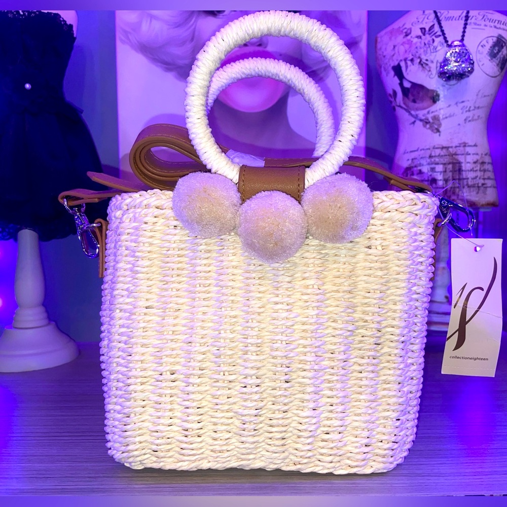 Off white small woven shoulder bag with Pom Pom accent.